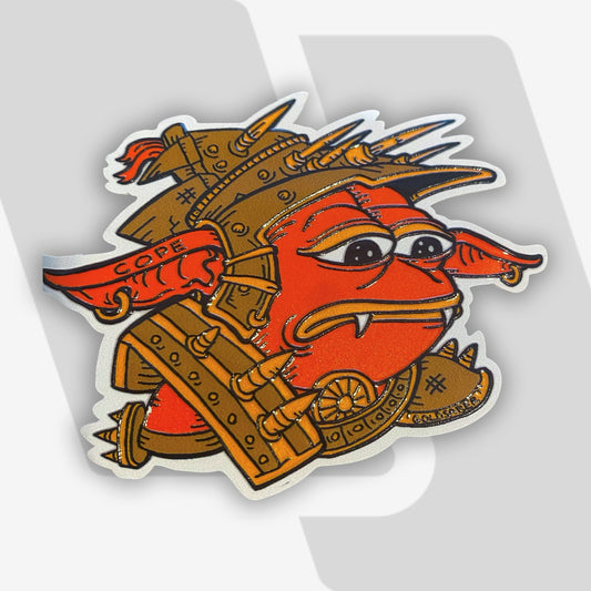 TopDeck.gg Sad Rograkh embossed sticker featuring a red goblin character in spiked armor with a sad expression, illustrated by Tim Taranto (@Goldsabertooth).